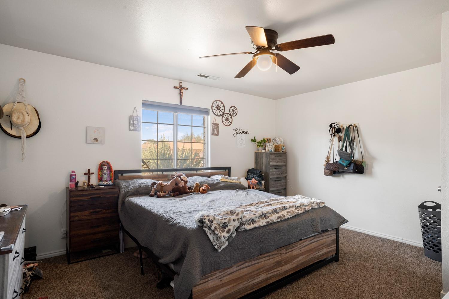 Bedroom with neutral wall paint and carpet flooring