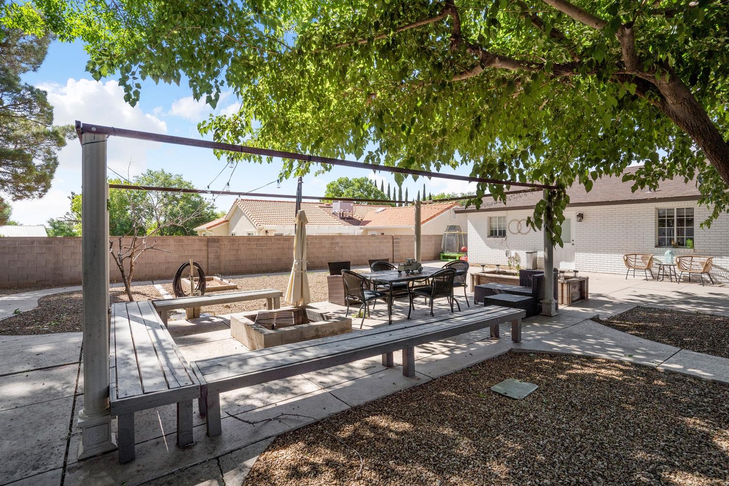 Outdoor patio featuring a pergola structure and built-in benches