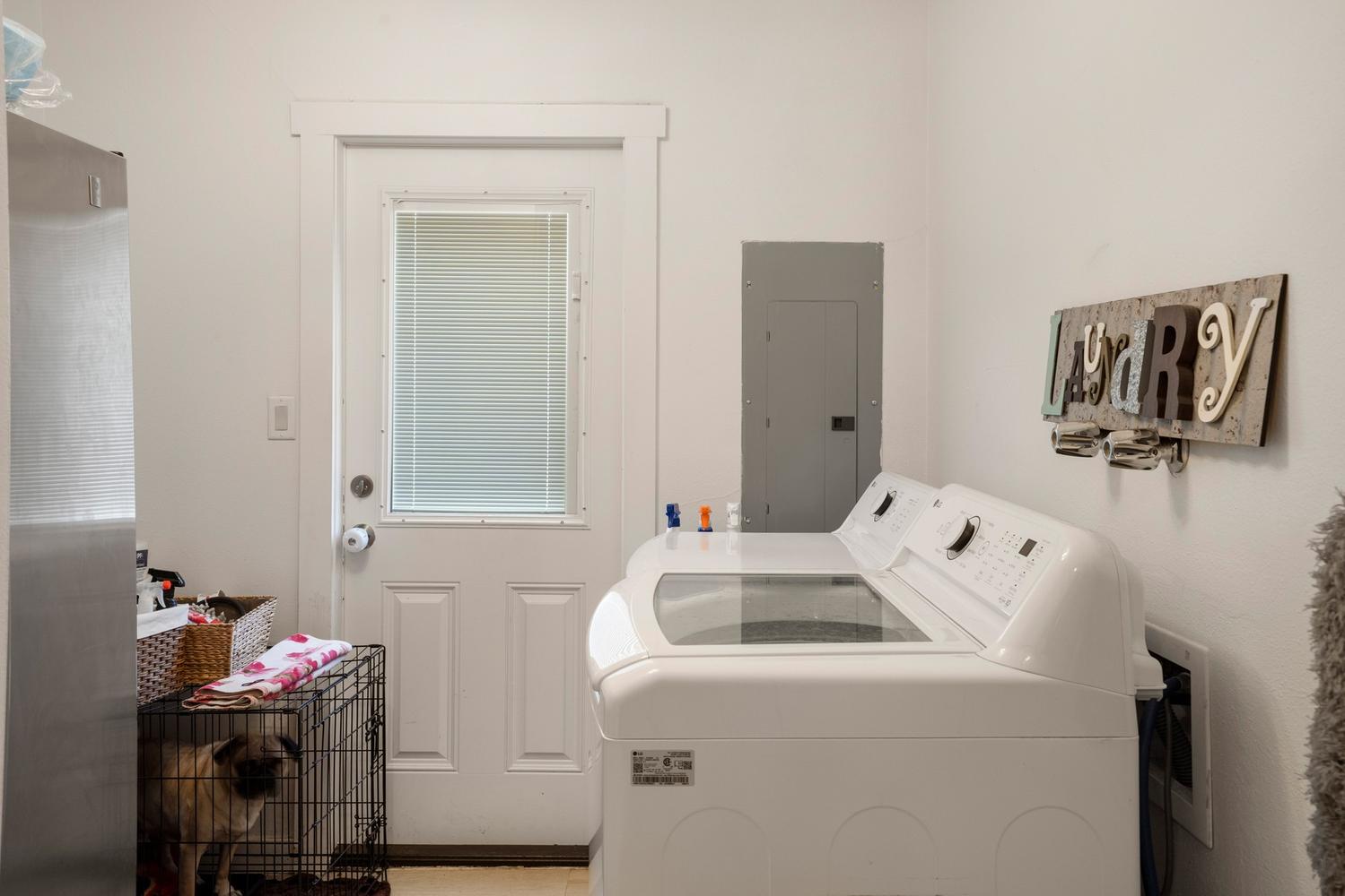 Utility room with light wood-finish flooring and white painted walls