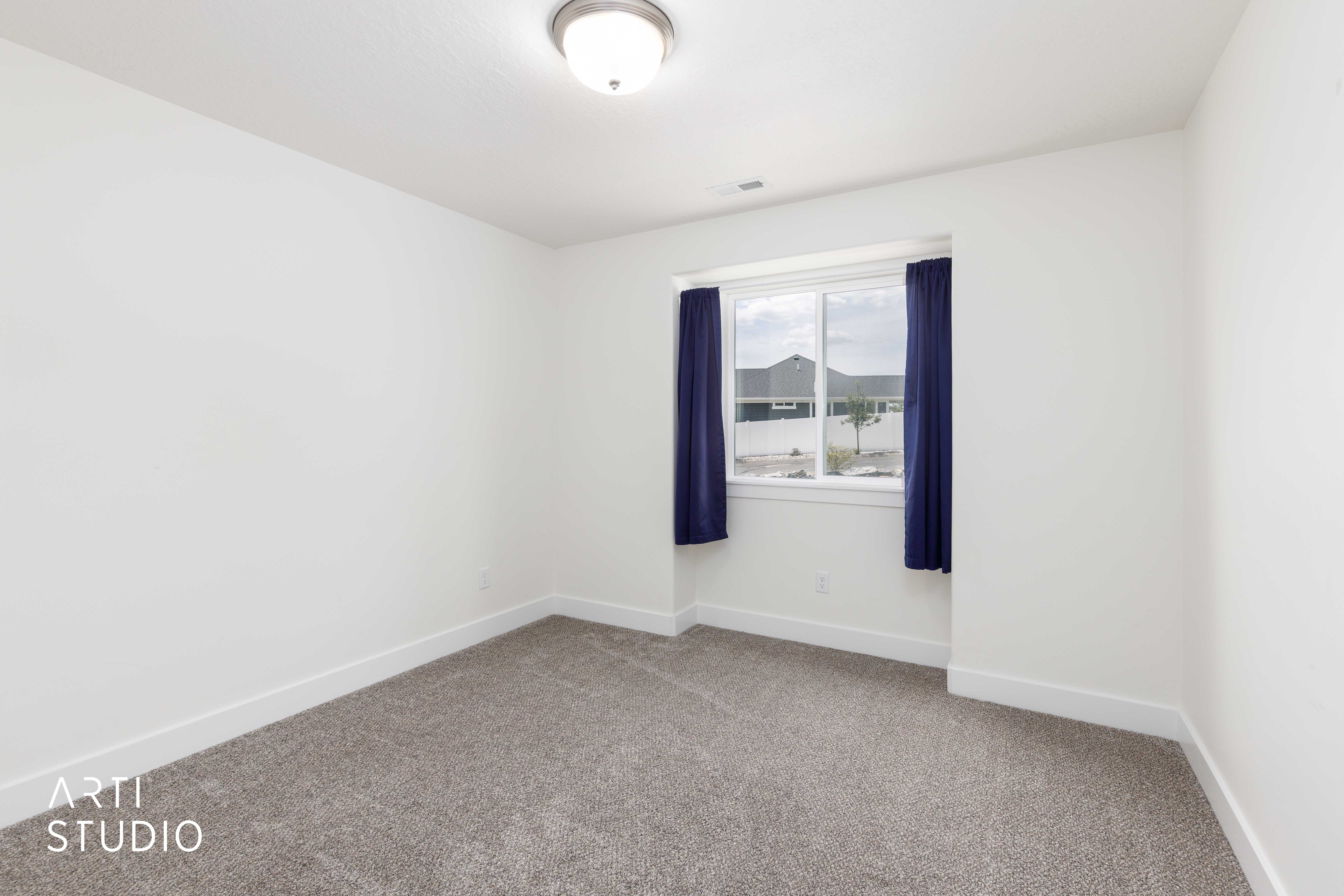 Room featuring neutral carpeting, white walls, and a window with a white frame