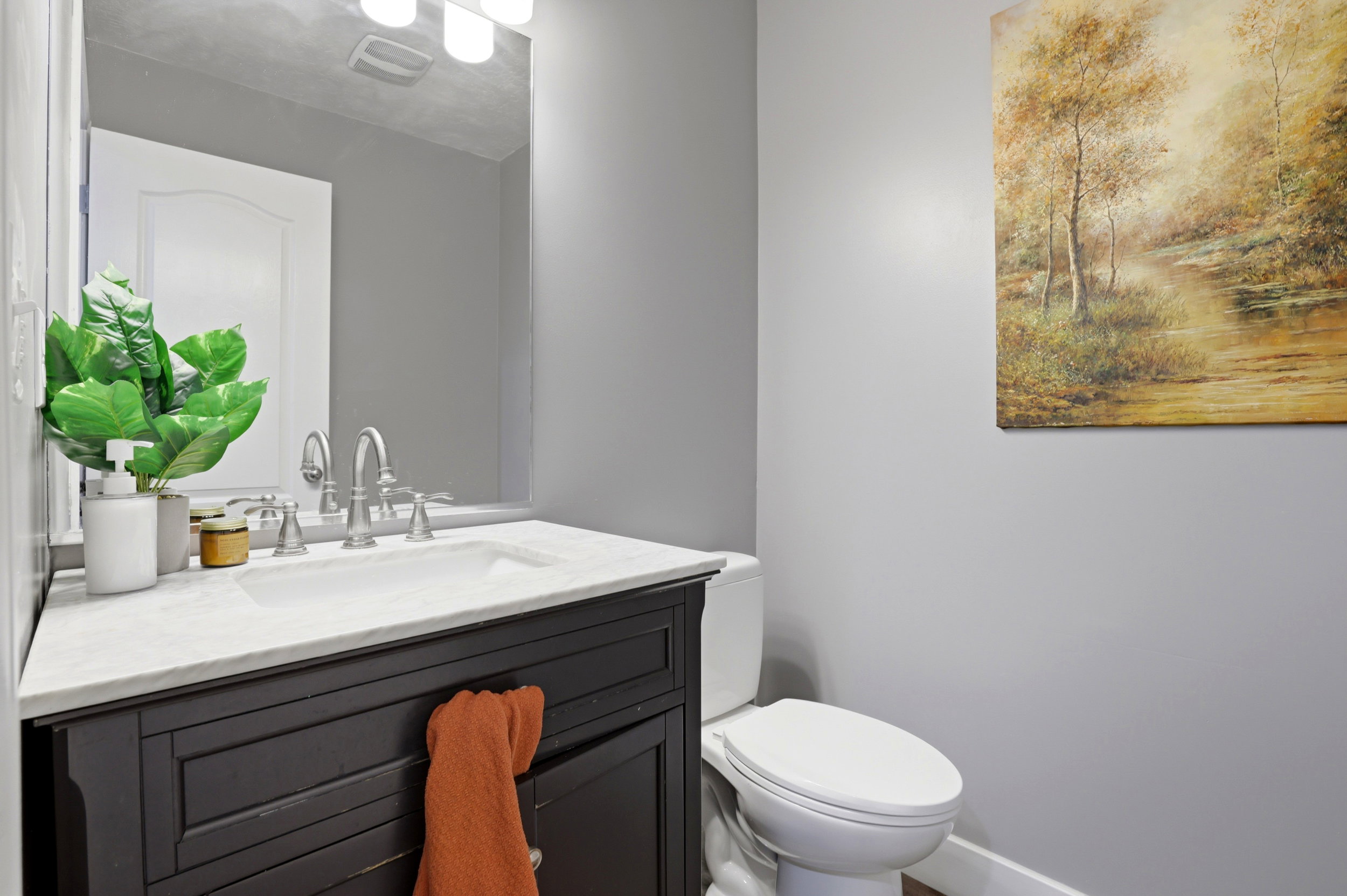 Vanity with an integrated white sink, brushed nickel faucet, and light-colored countertop