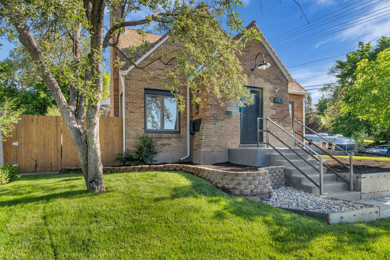 Brick residence featuring a gabled roofline and prominent front entry