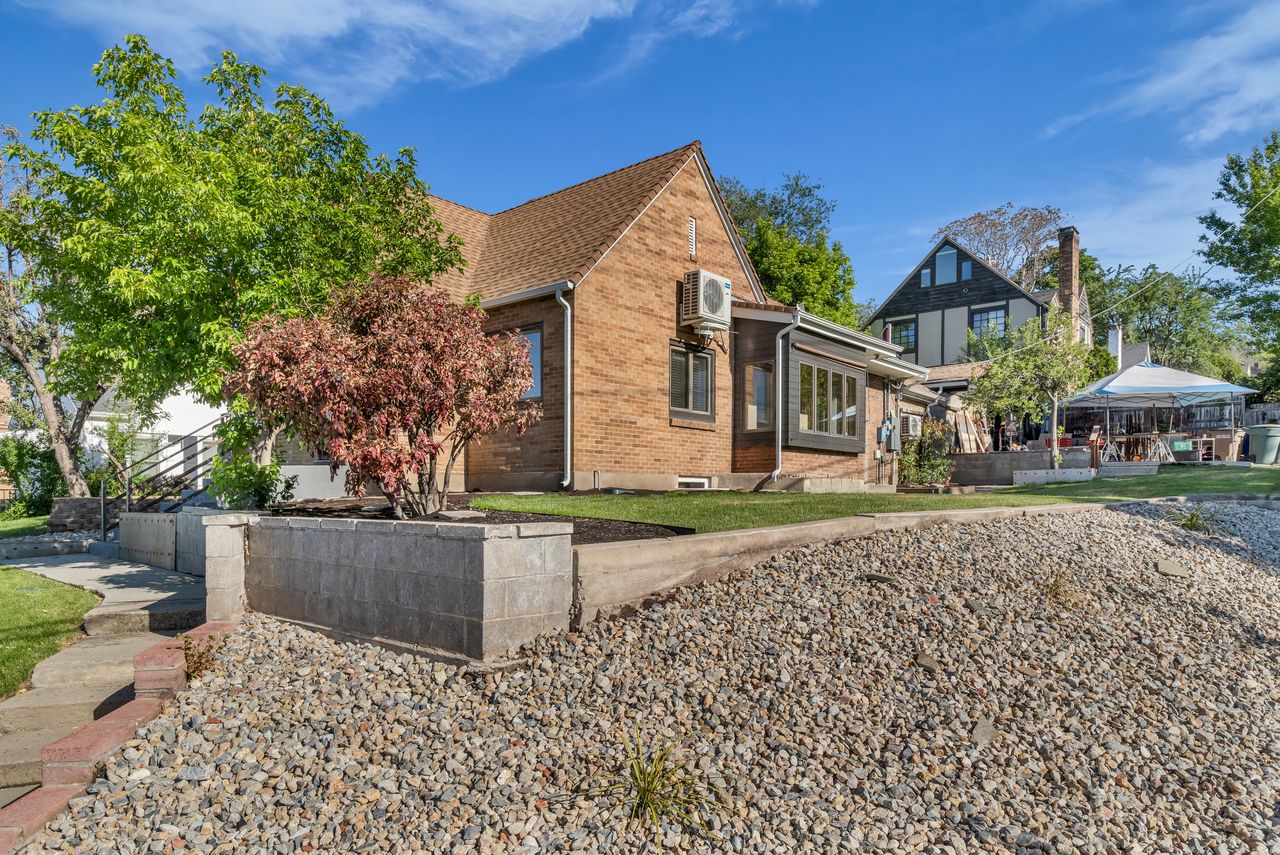 Brick exterior with a brown shingle roof