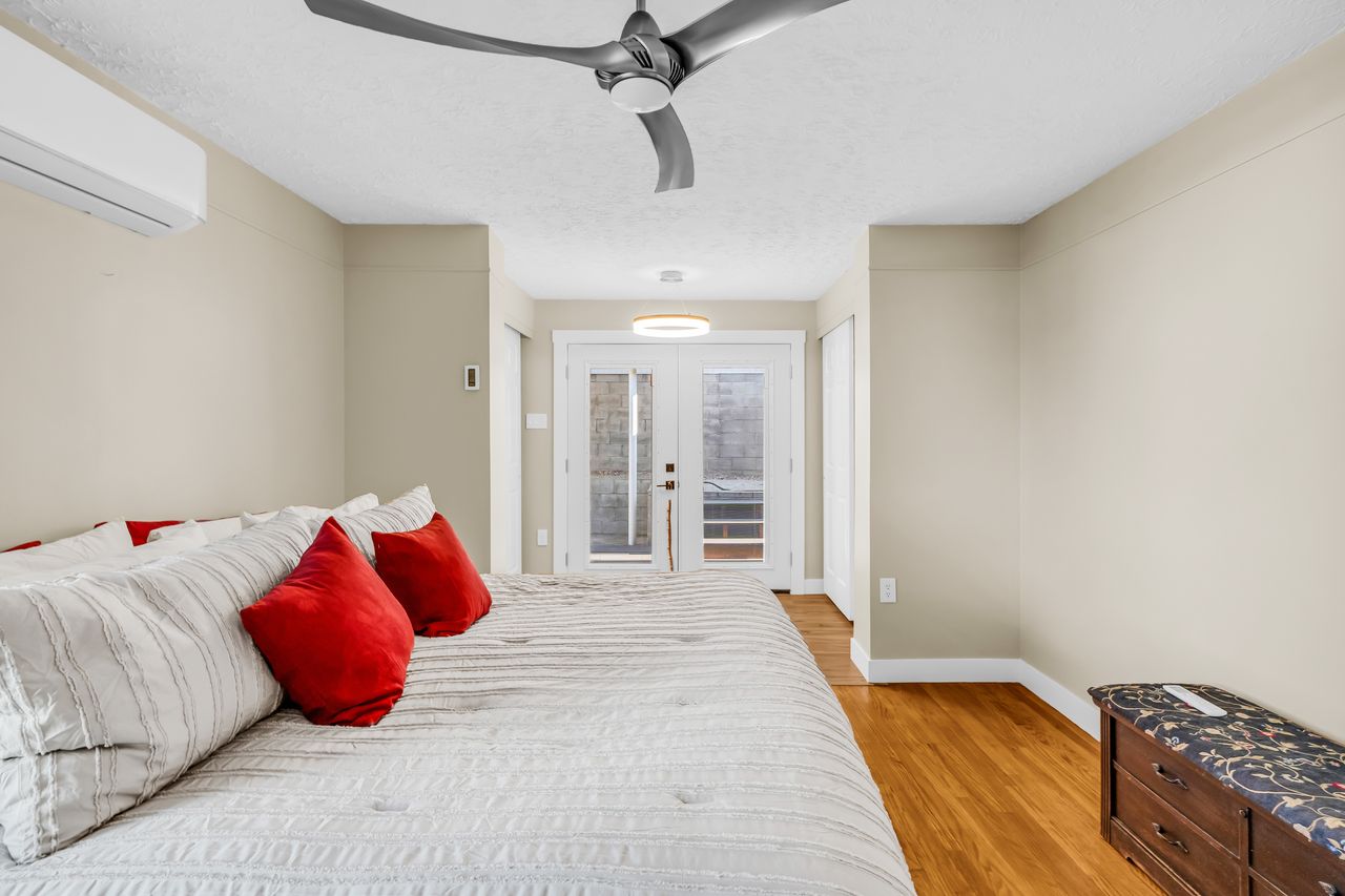 Room featuring wood-finish flooring, a contemporary ceiling fan, and recessed lighting