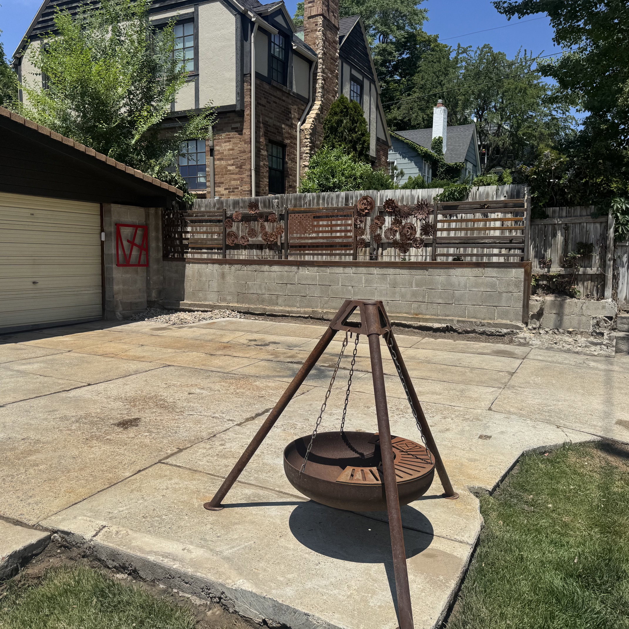 Concrete patio area with a unique metal fire pit