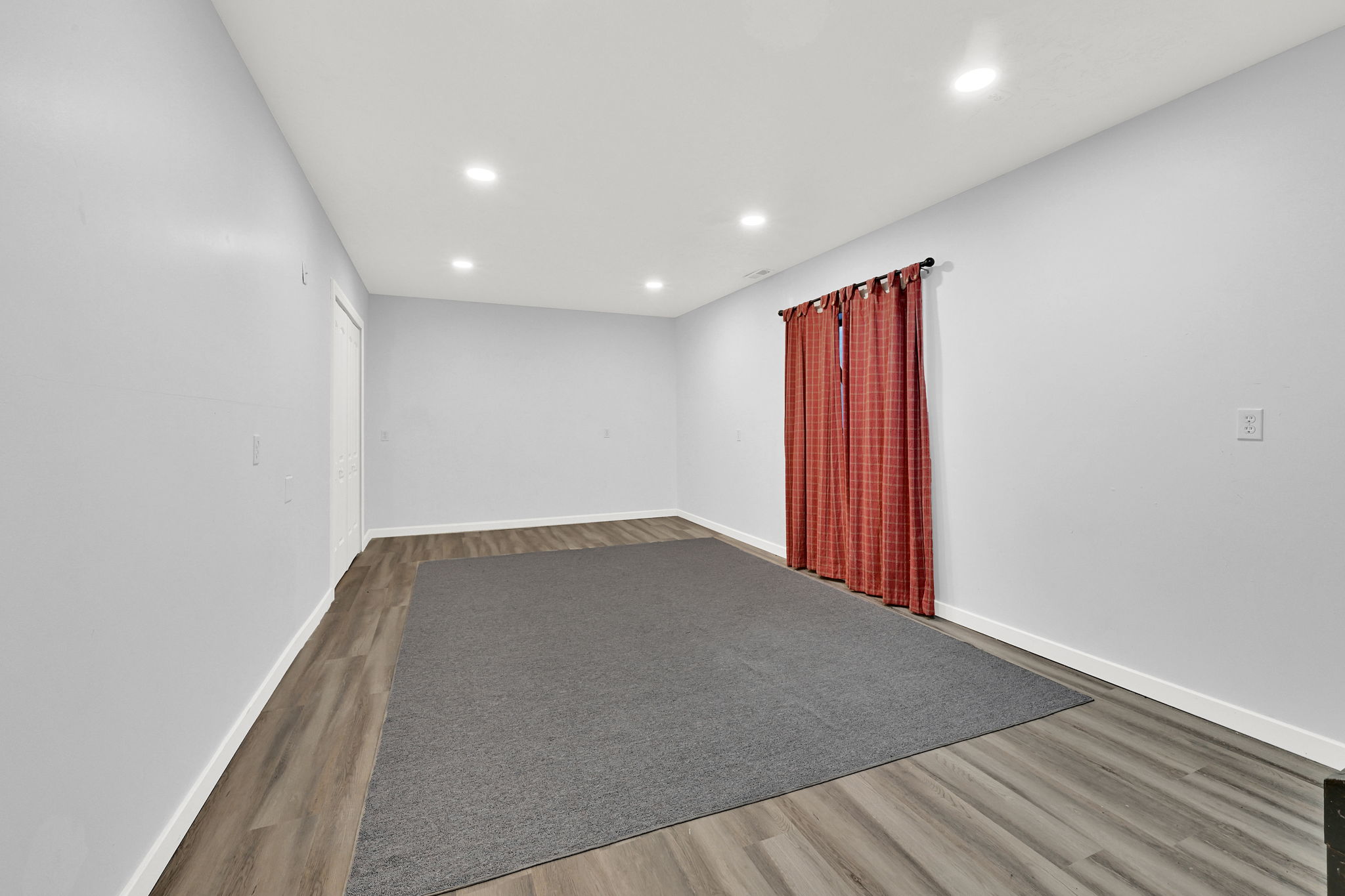 Spacious bedroom #4 featuring wood-finish flooring, recessed ceiling lighting, and light gray walls