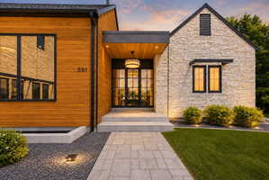 Modern exterior showcasing a combination of wood-finish siding and stone facade
