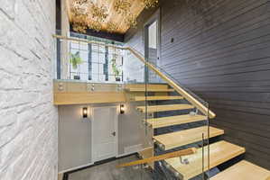 Modern floating staircase featuring natural wood treads and glass railings