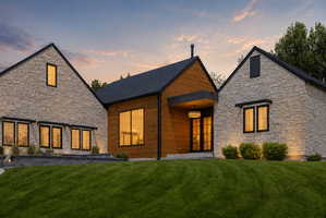 Exterior featuring stone veneer and vertical wood siding