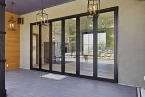 Exterior deck featuring gray composite decking and a purple-hued ceiling