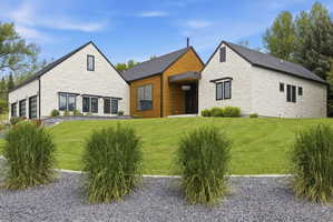 Contemporary architectural design featuring white stone cladding and wood-paneled accents