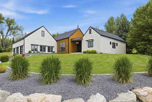 Contemporary architecture featuring a white brick and natural wood exterior