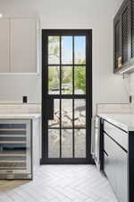 Black-framed glass-paneled door opening to an outdoor area