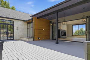 Expansive outdoor deck featuring a composite surface and stone veneer exterior