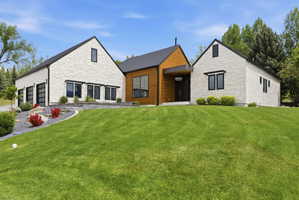 Modern architecture featuring a combination of stone veneer and wood siding