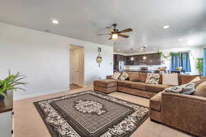 Open-concept living space featuring recessed lighting and a ceiling fan