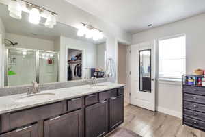 Dual vanity with a speckled countertop, undermount sinks, and brushed nickel faucets