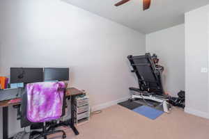 Carpeted room with light-colored walls and a ceiling fan