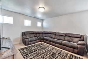 Carpeted room with multiple rectangular windows featuring blinds