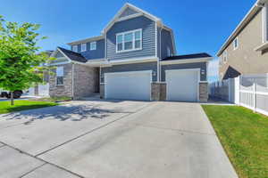 Contemporary two-story exterior featuring blue siding and stone veneer accents
