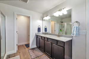 Double vanity with stone-finish countertop and dark wood cabinetry