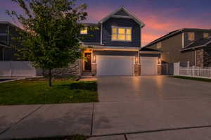 Contemporary residence featuring blue siding and stone accents