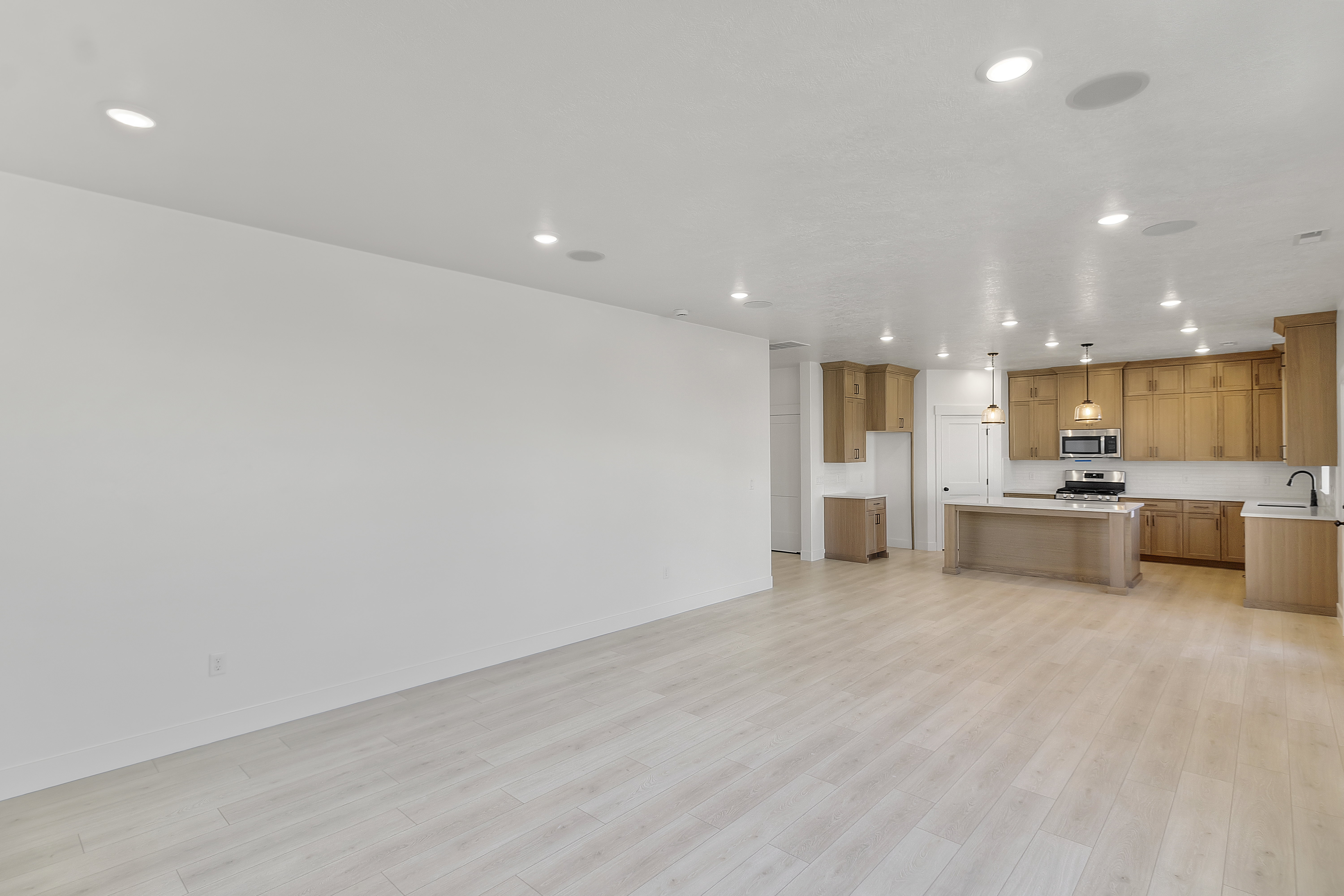 Open-concept living space featuring light wood-finish flooring throughout