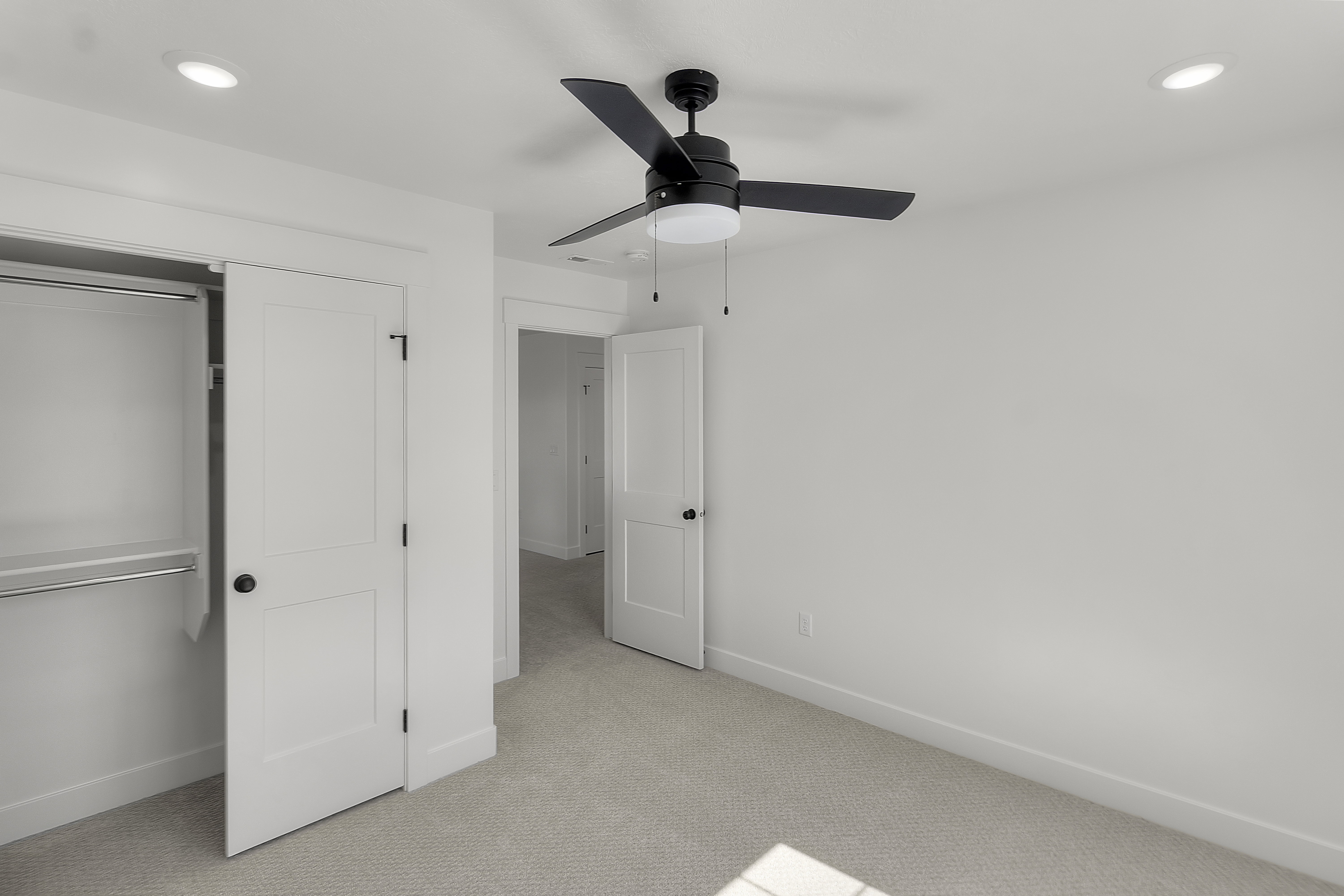 Bedroom featuring light-toned carpeting, a ceiling fan with integrated lighting, recessed ceiling lights, and a closet with a built-in hanging rod and shelf