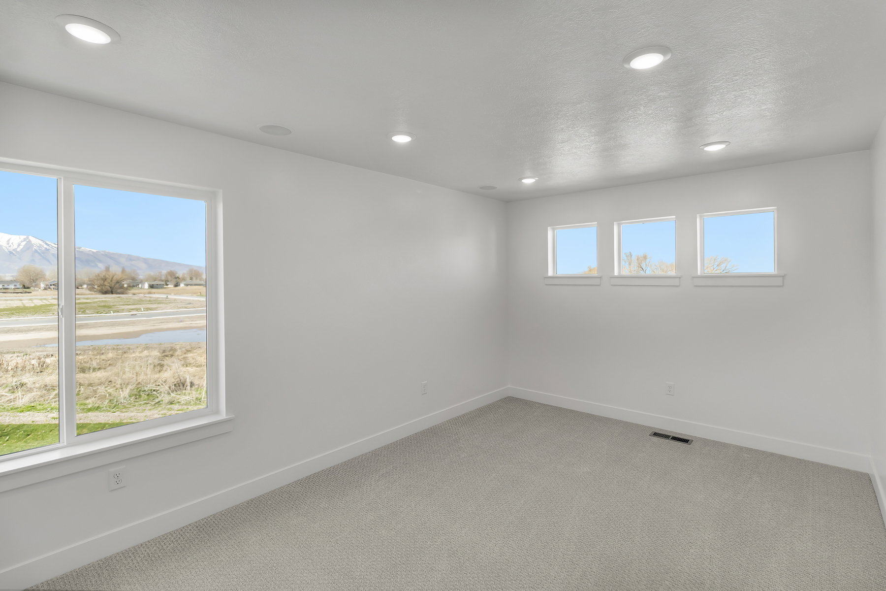 Bright room with a large picture window and three transom windows
