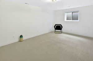 Spacious room with light-toned carpeting and neutral white walls