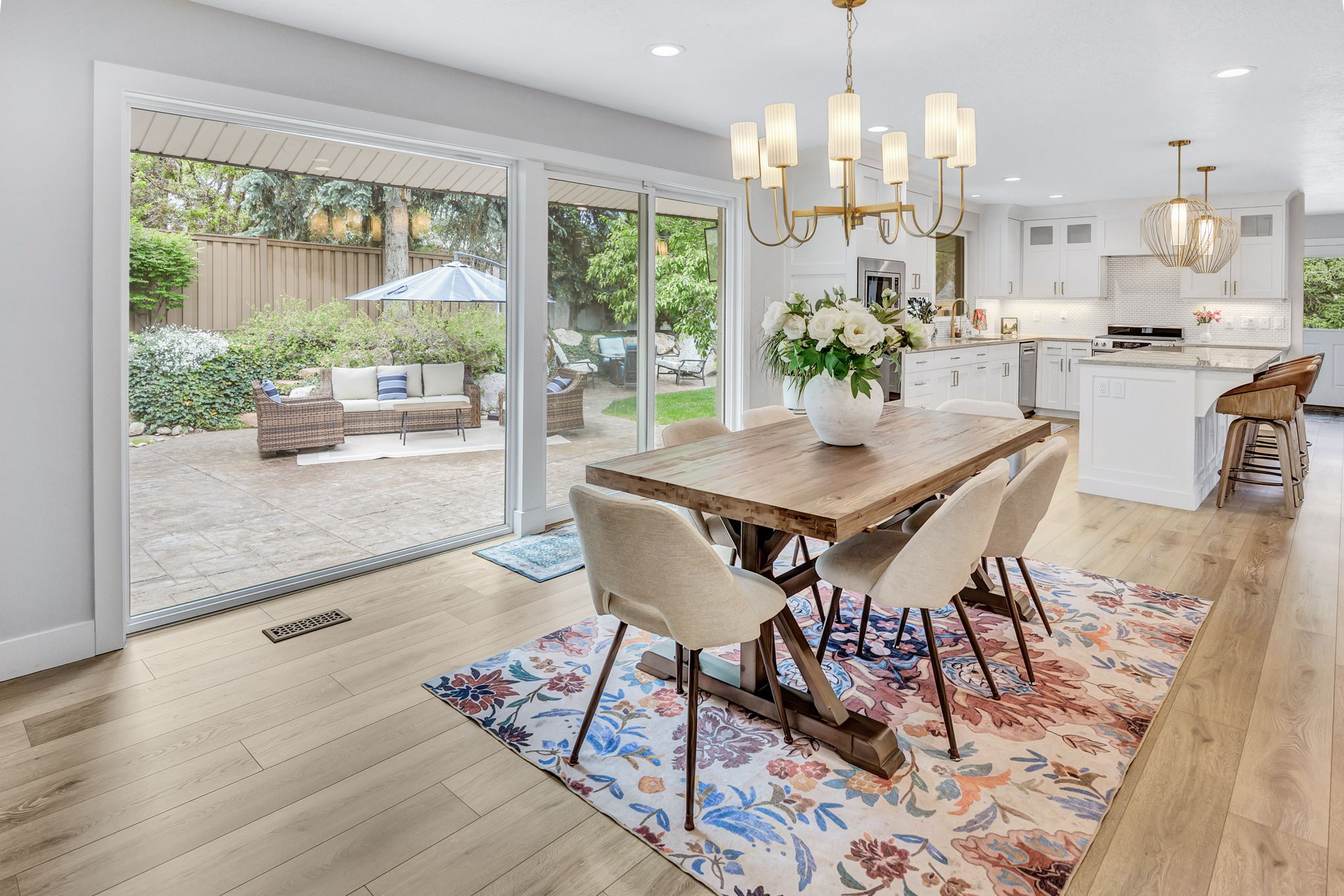 Dining area with light wood-finish flooring and a contemporary chandelier