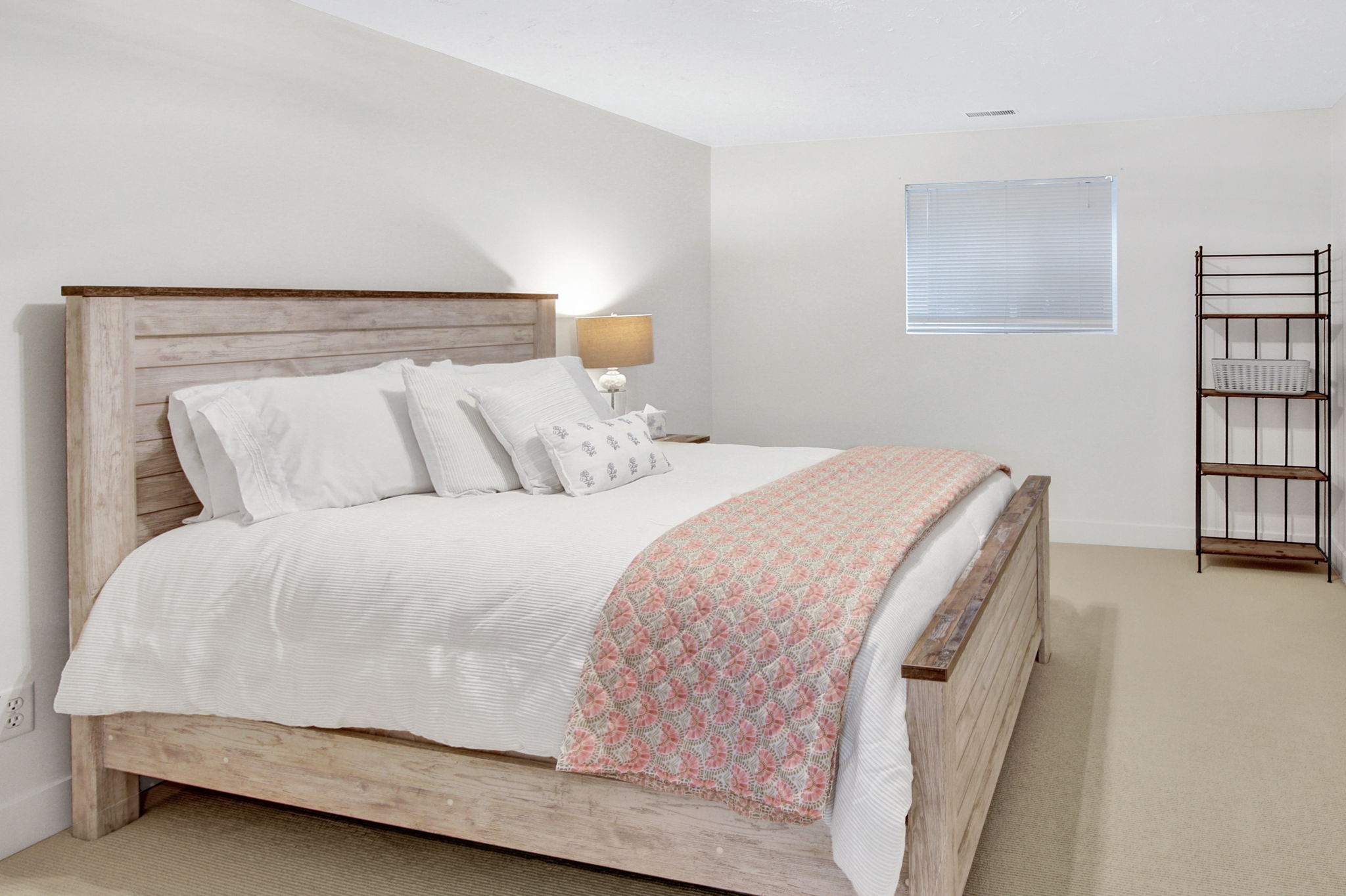 Bedroom featuring light-toned carpeting and white wall finishes