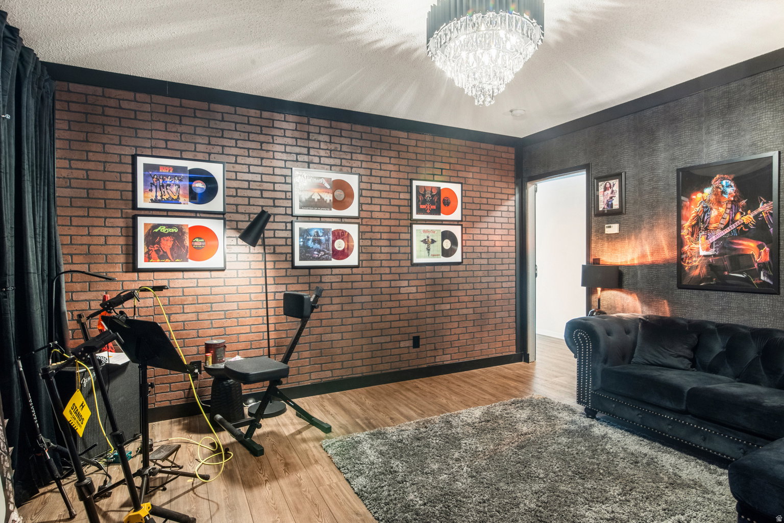 Exposed brick-finish wall accenting a room with wood-finish flooring