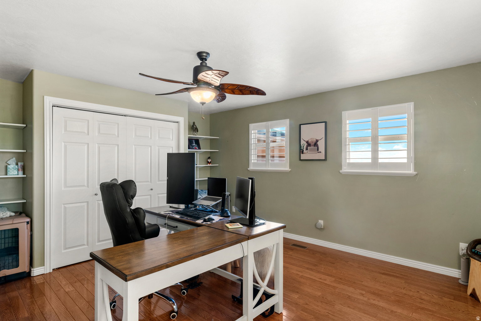 Warm wood-finish flooring complements the neutral wall color