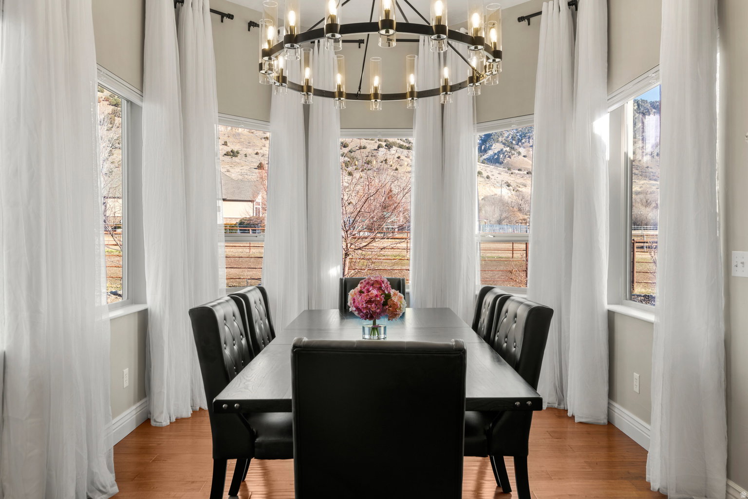 Dining area with a bay window design featuring multiple large windows