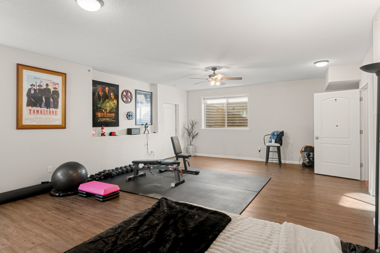 Spacious room with wood-finish flooring, recessed lighting, and a ceiling fan