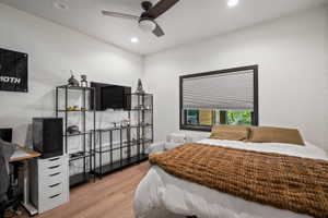 Bright room featuring wood-finish flooring and recessed lighting