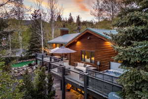 Log cabin exterior with a multi-level deck system
