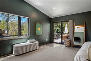 Spacious room with dark green walls and gray carpeting