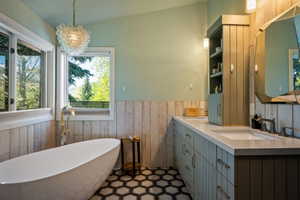 Freestanding soaking tub with floor-mounted faucet