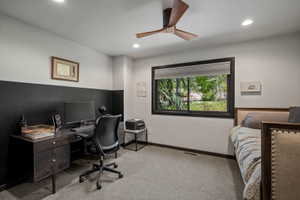 Room featuring a modern wood-blade ceiling fan, recessed lighting, and a large window with a dark frame