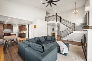 Open-concept living space featuring high ceilings and wood-finish flooring