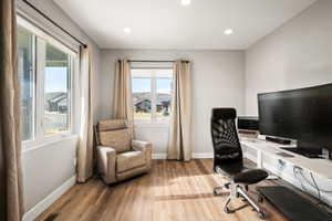Room featuring light wood-finish flooring and recessed lighting