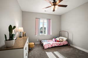 Neutral wall paint with window, ceiling fan, and carpet flooring