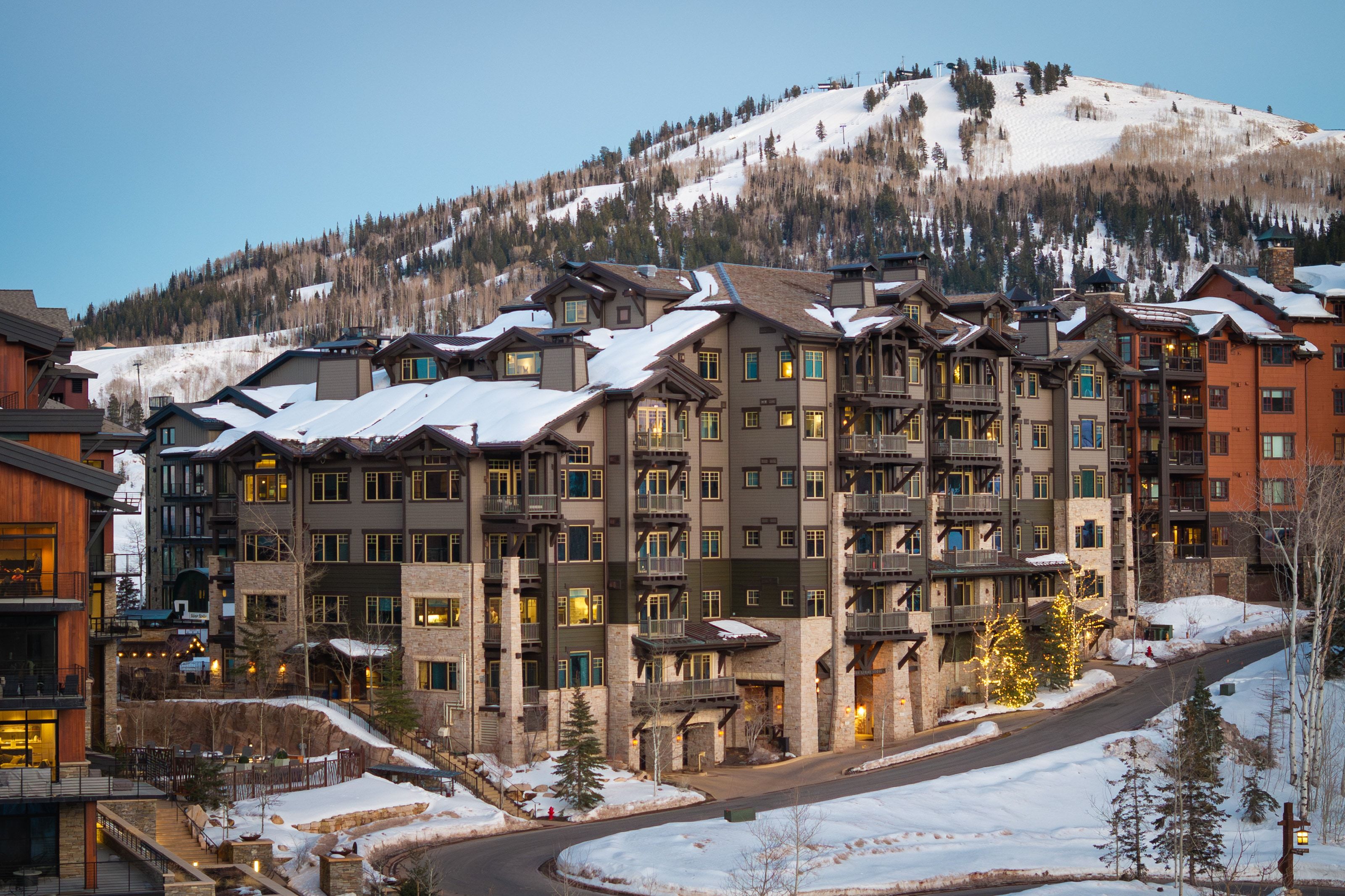 Multi-story residential building with stone and wood-panel accents