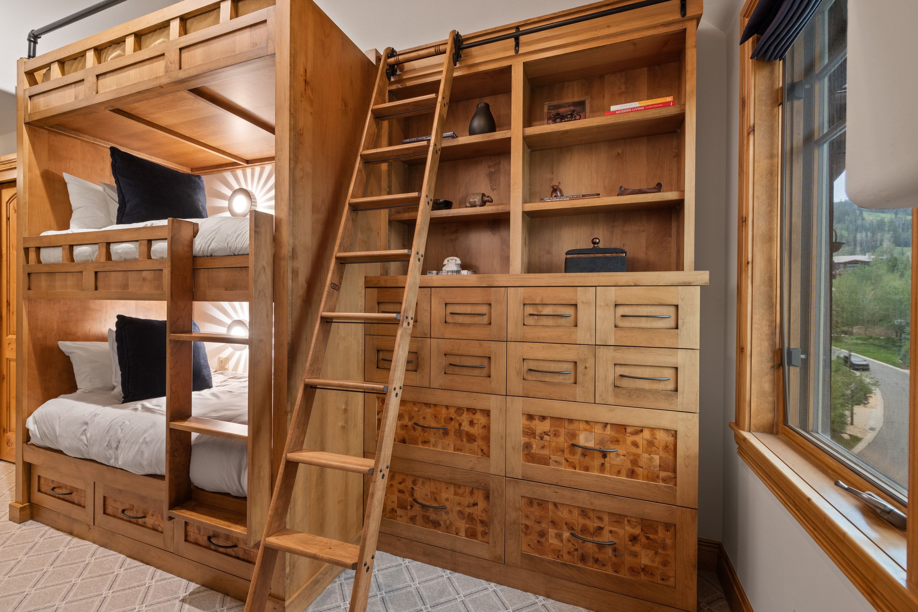 Built-in wooden bunk beds with integrated lighting and storage drawers