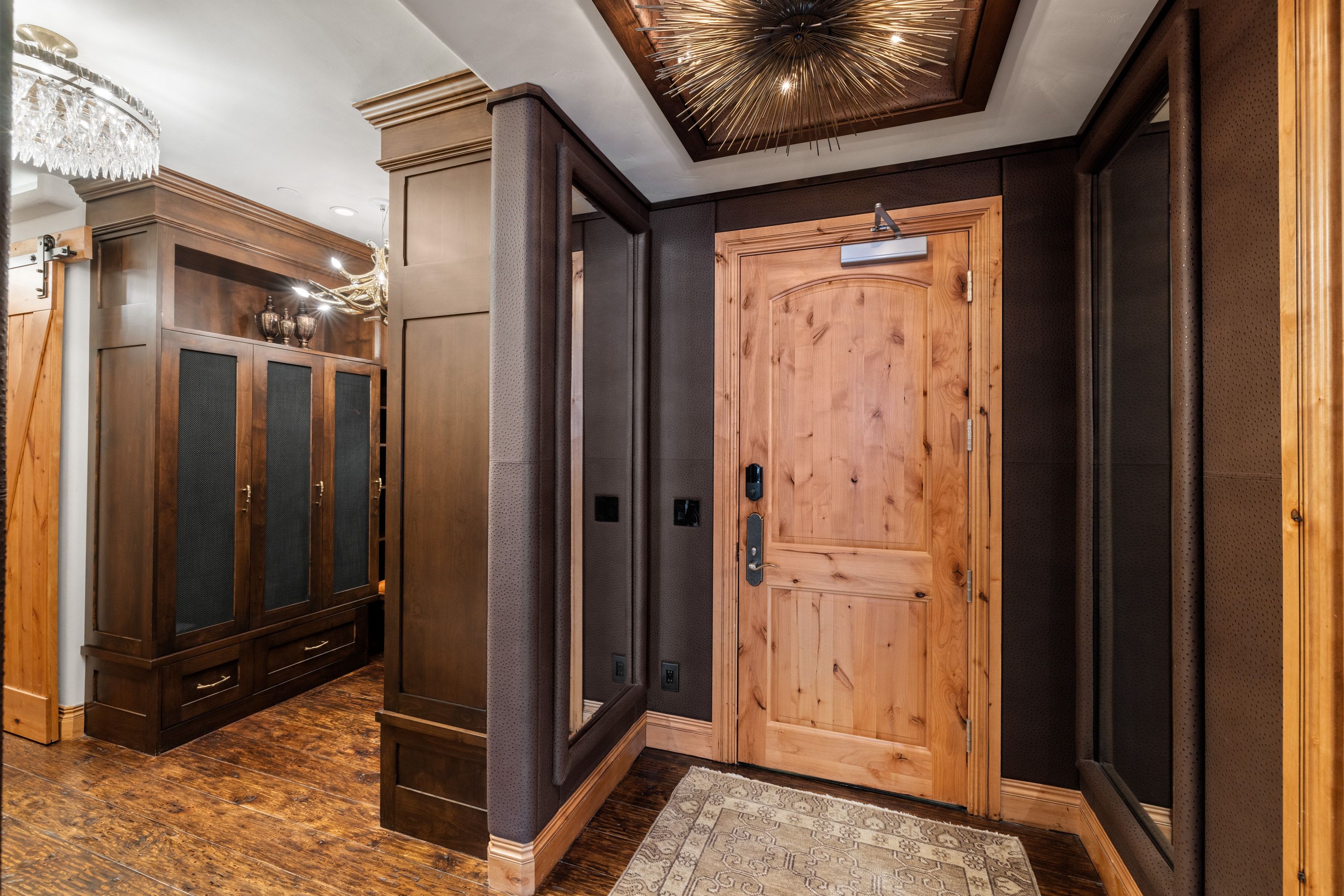 Entryway featuring a natural wood door with a digital lock