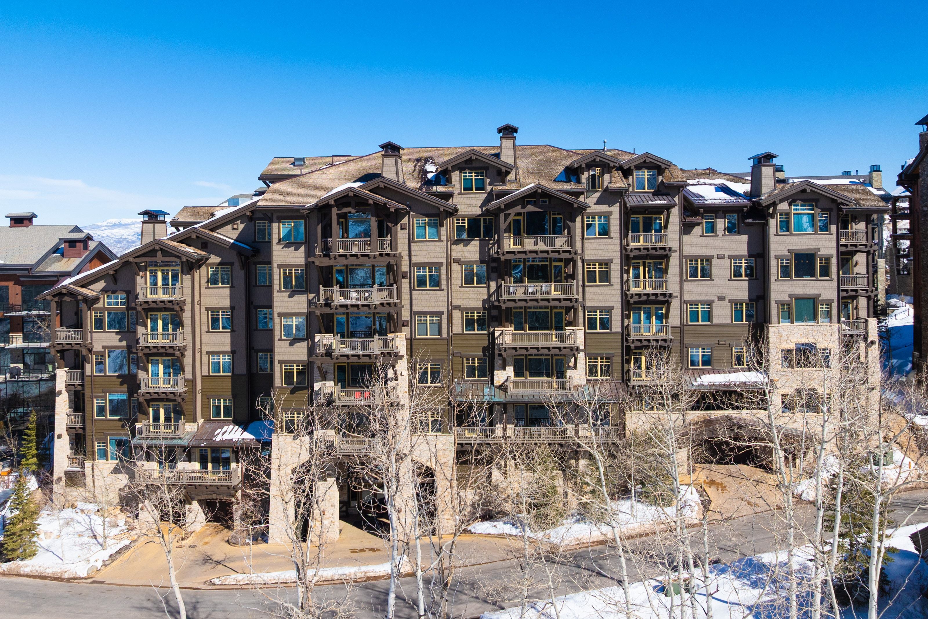 Multi-story building featuring stone and stucco exterior finishes