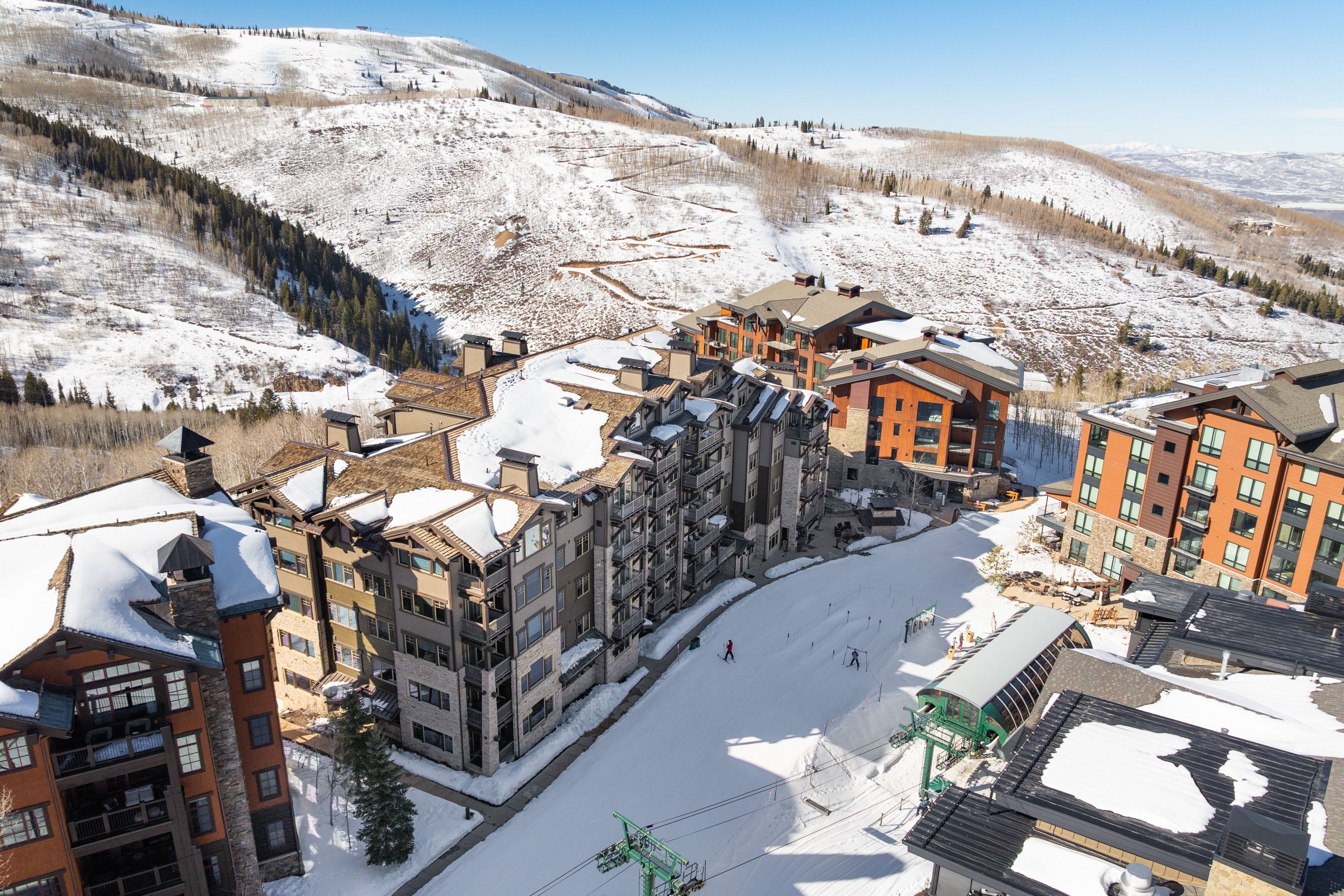 Mountain-side residences featuring varied architectural styles and materials including stone and wood paneling