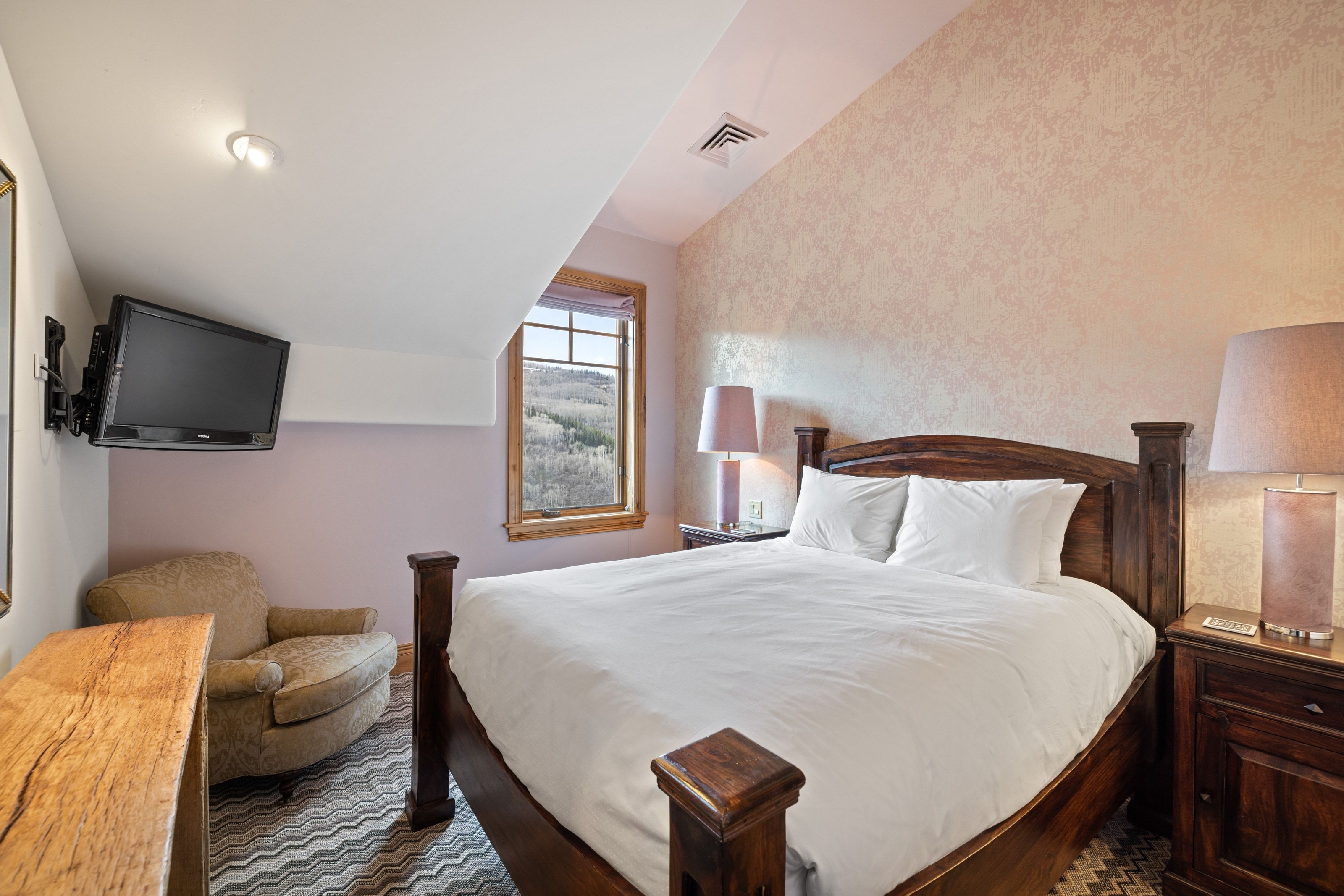 Room featuring a large window, patterned accent wall, and recessed ceiling lighting